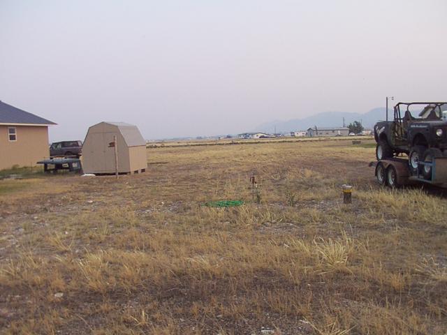 Width between shed/garage and where the well is, and the trailer gettin' close to the property line.