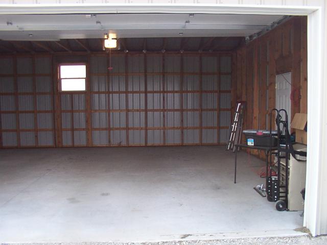 Standing outside the double-wide shop door.  Floor has been mostly swept.