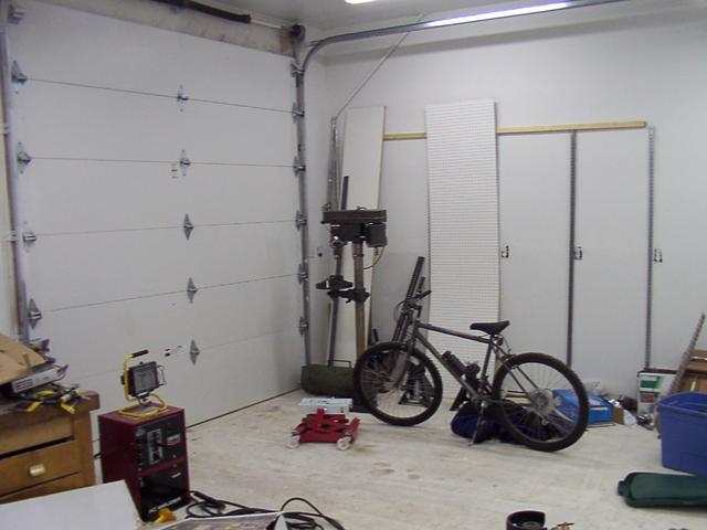 This corner is part of the work-bay.  Uprights on the wall are for moveable shelf brackets for steel stock storage