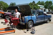 Tom poses after removing the "new" 392 from Tom's Travelette at the Gryphin Auto shop in Aurora