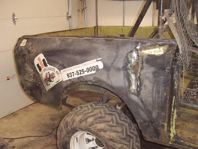 Grinding paint on the big dents prior to welding machine screws to it for pulling