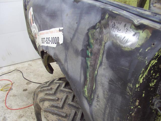 Grinding paint on the big dents prior to welding machine screws to it for pulling