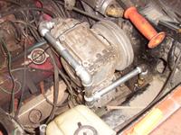Metal piping T-s forward to the front bumper air tank, with a short hose section going straight down - far from the compressor o