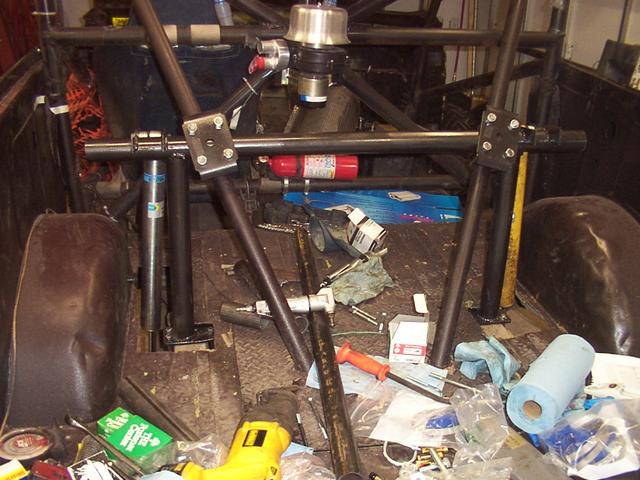 Wide angle view with U-bolts holding the upright to the rear kickers of the cage